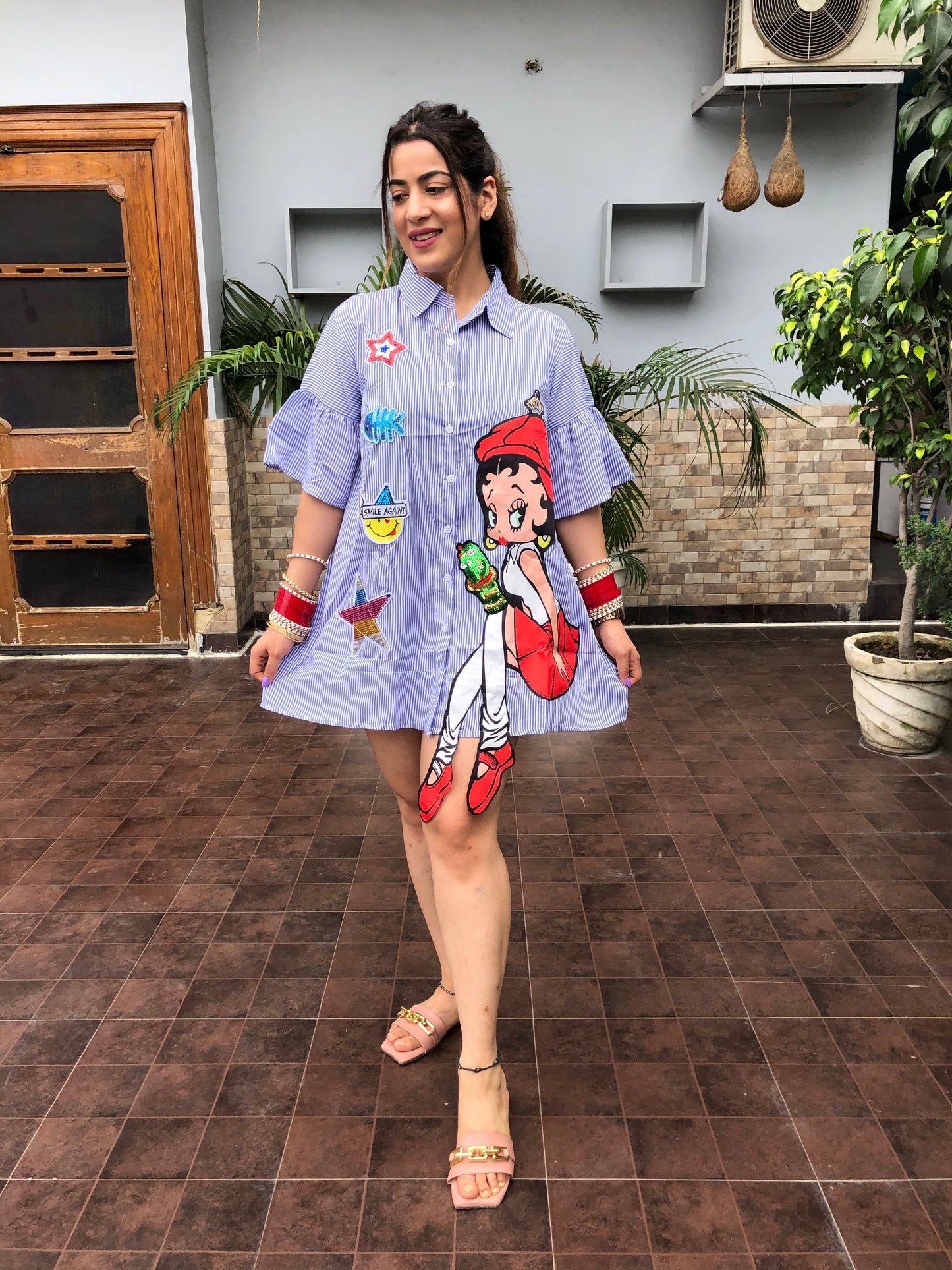 a woman wearing blue stripe print doll shirt