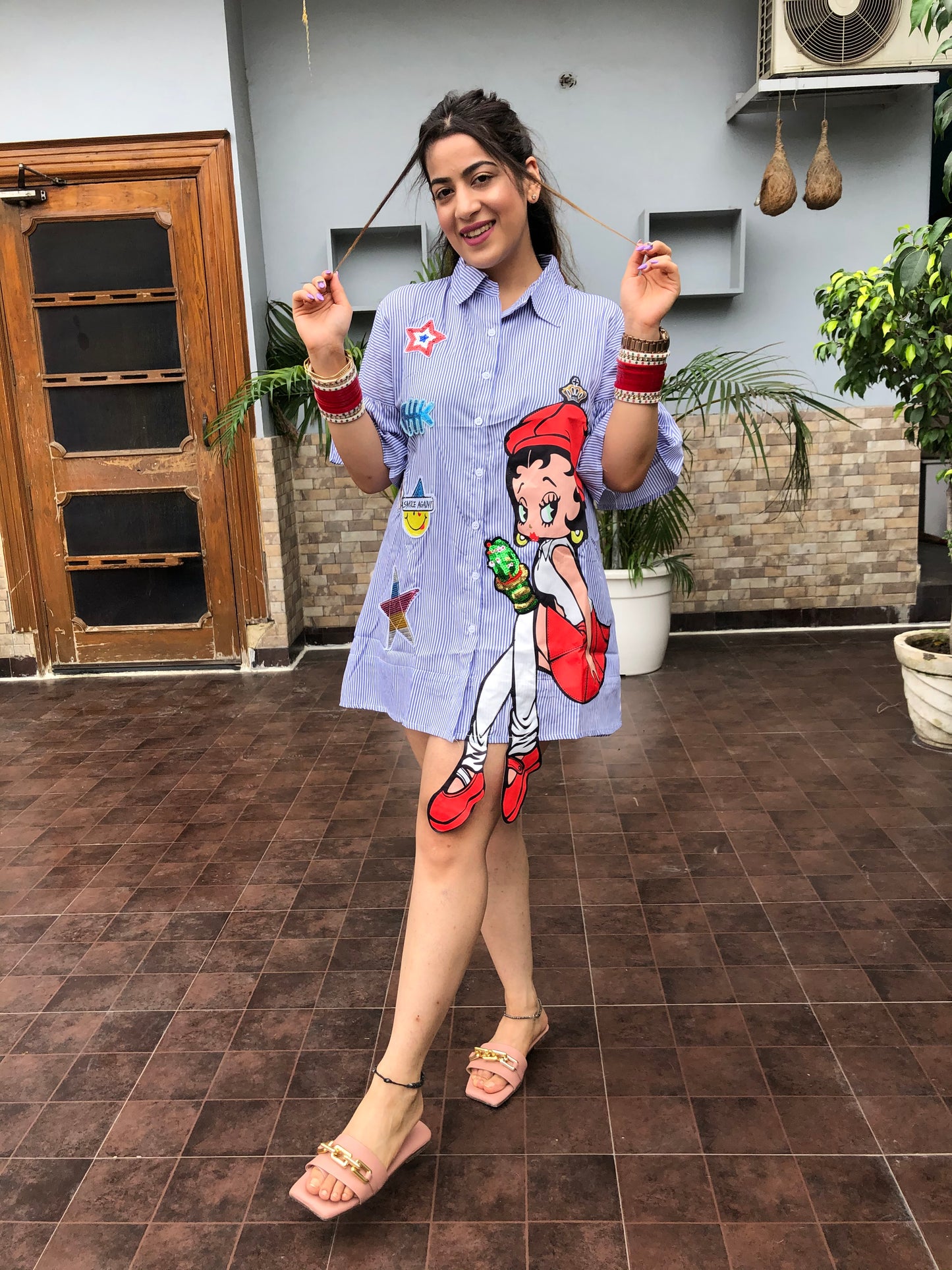a woman wearing blue stripe print doll shirt