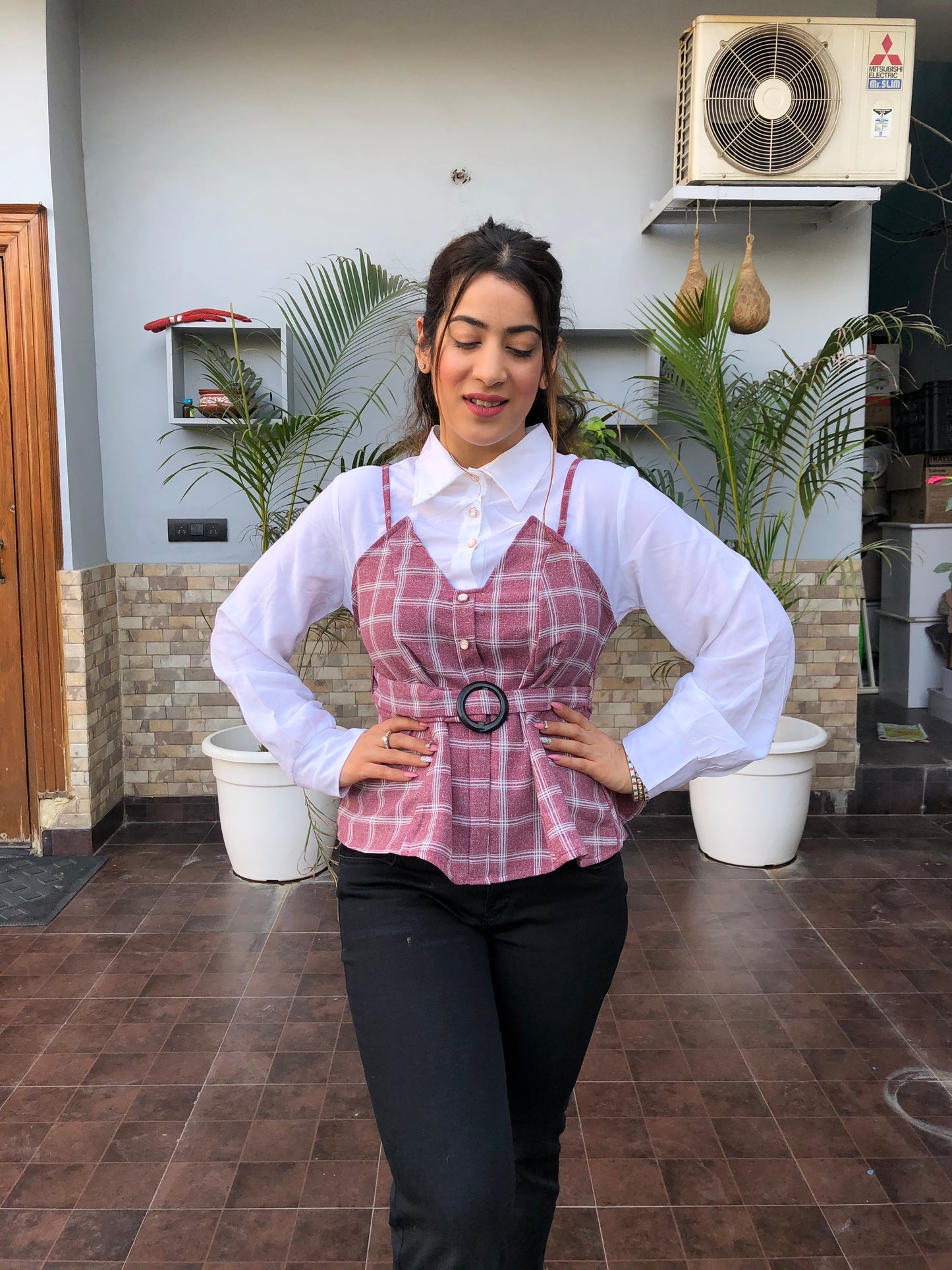 a woman wearing pink checked top with polo collar