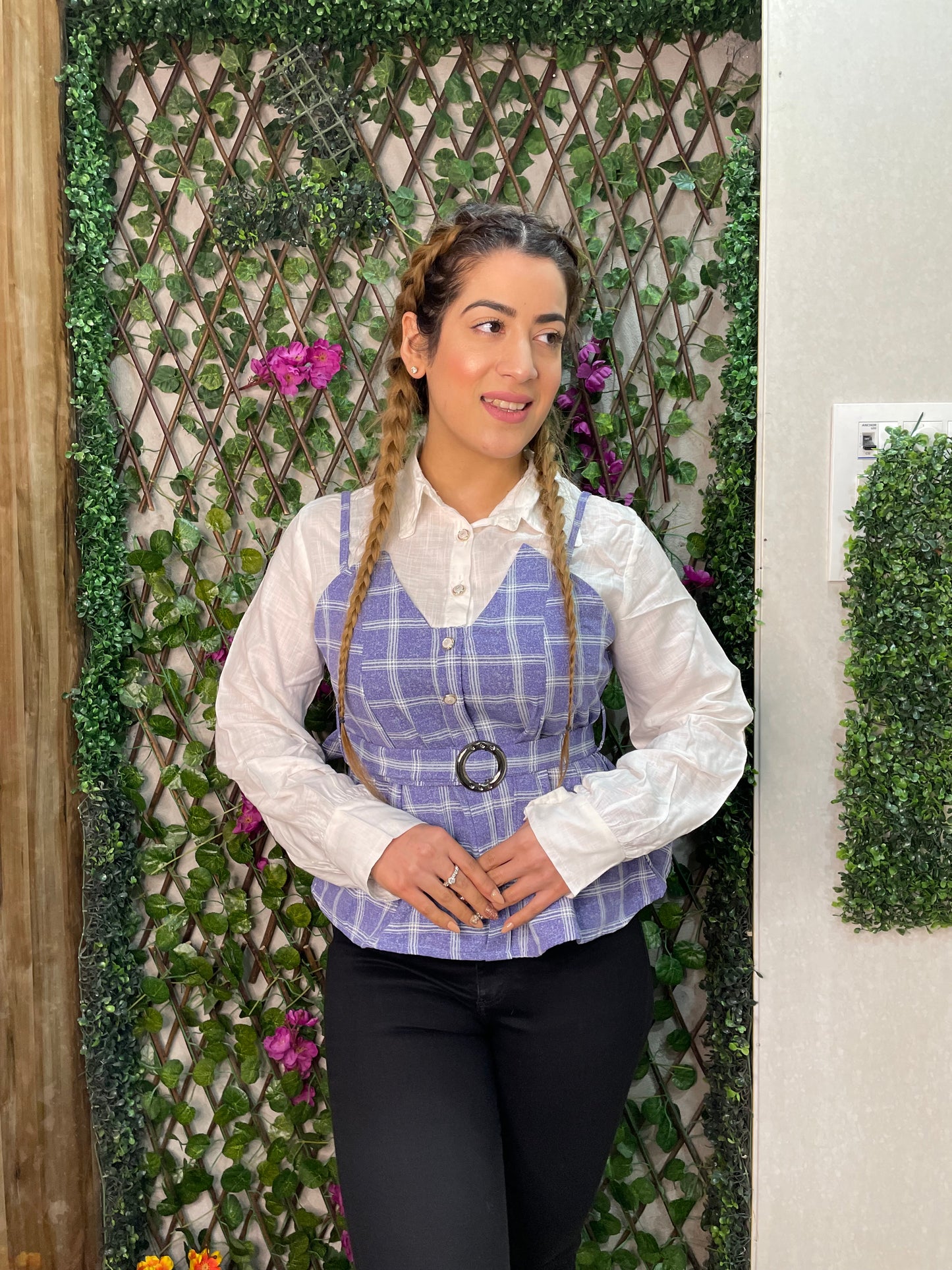 a woman wearing blue checked top with polo collar