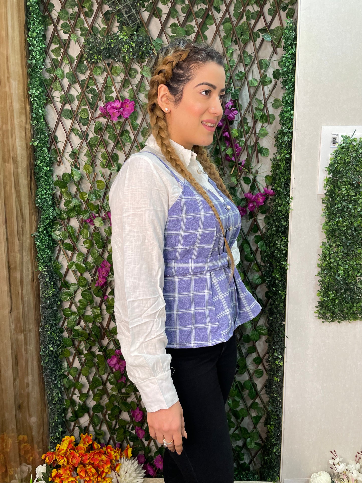 a woman wearing blue checked top with polo collar