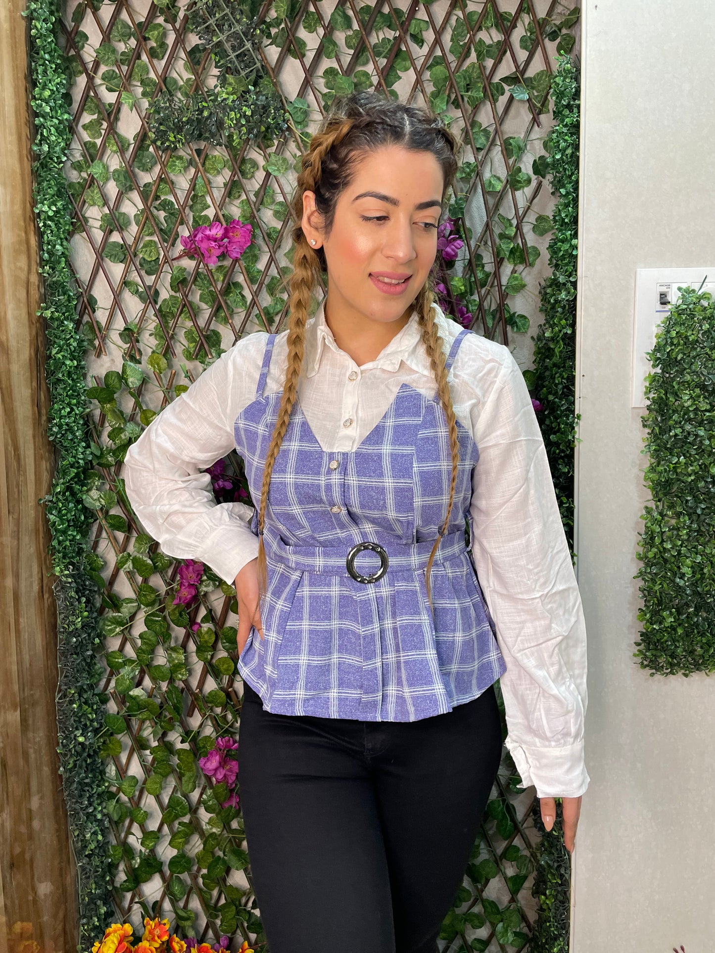 a woman wearing blue checked top with polo collar