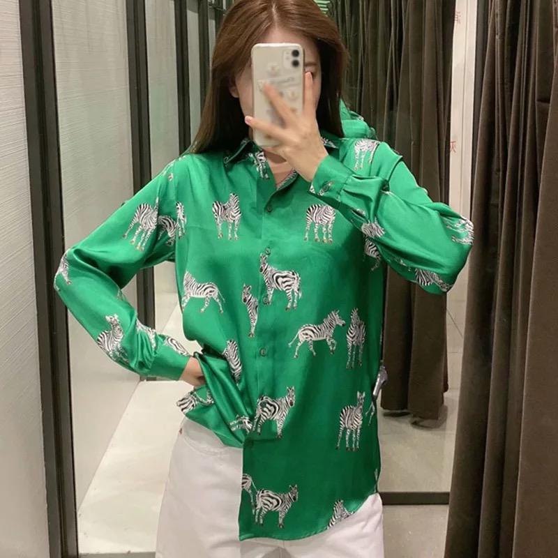 A girl wearing green zebra print shirt