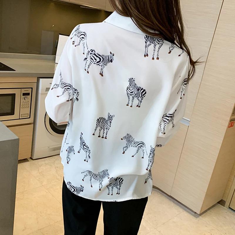 A girl wearing white zebra print shirt