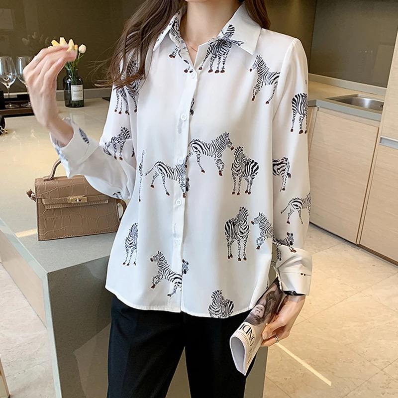 A girl wearing white zebra print shirt