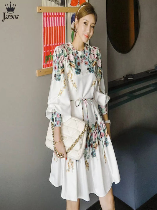 a woman wearing white floral print skater dress with belt