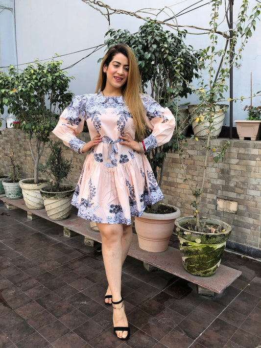 a woman wearing peach floral skater dress