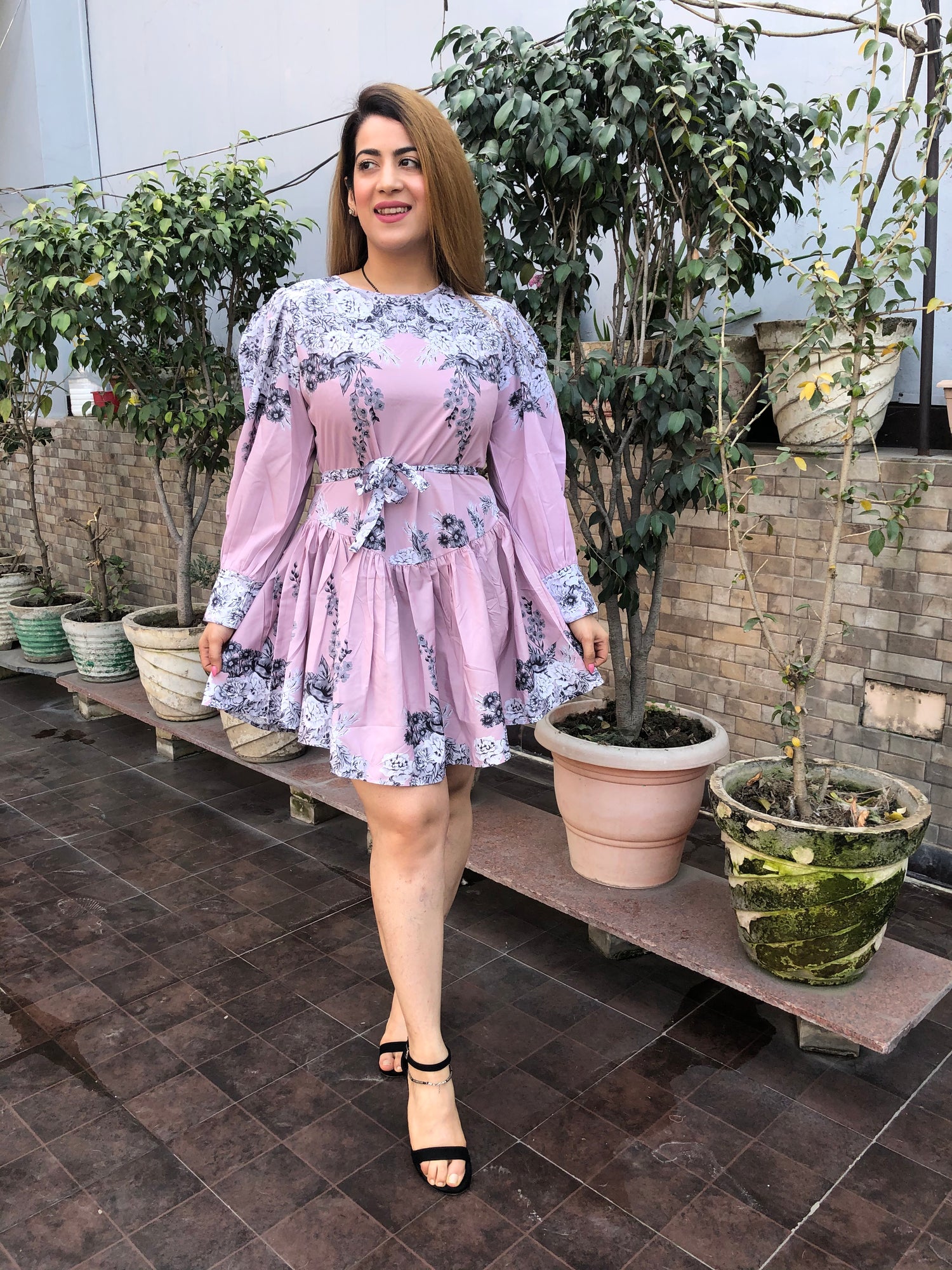 a woman wearing pink floral skater dress