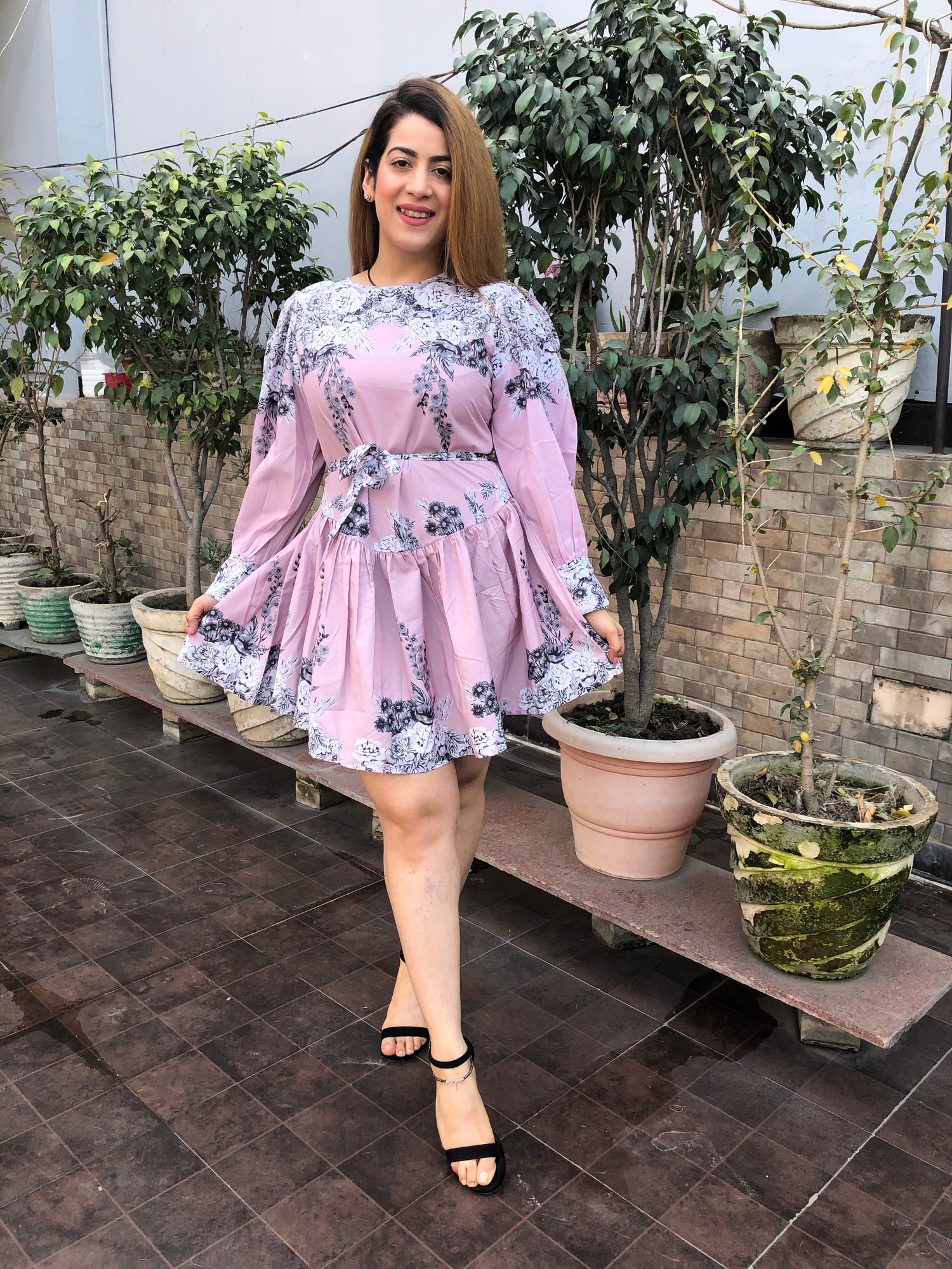 a woman wearing pink floral skater dress