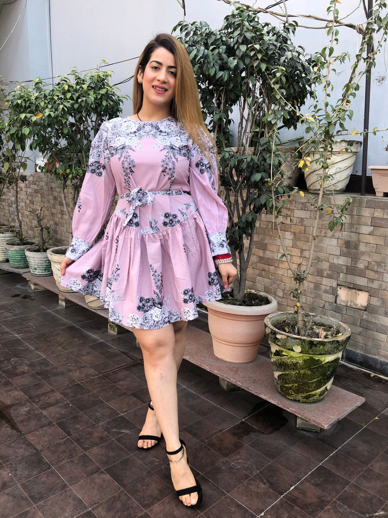 a woman wearing pink floral skater dress