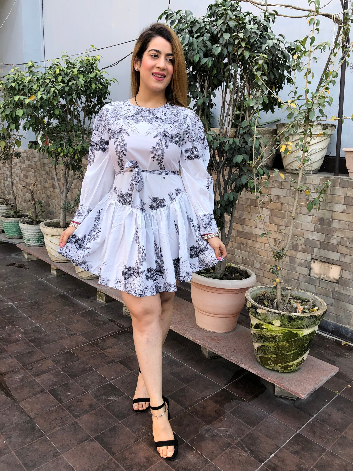 a woman wearing white floral skater dress