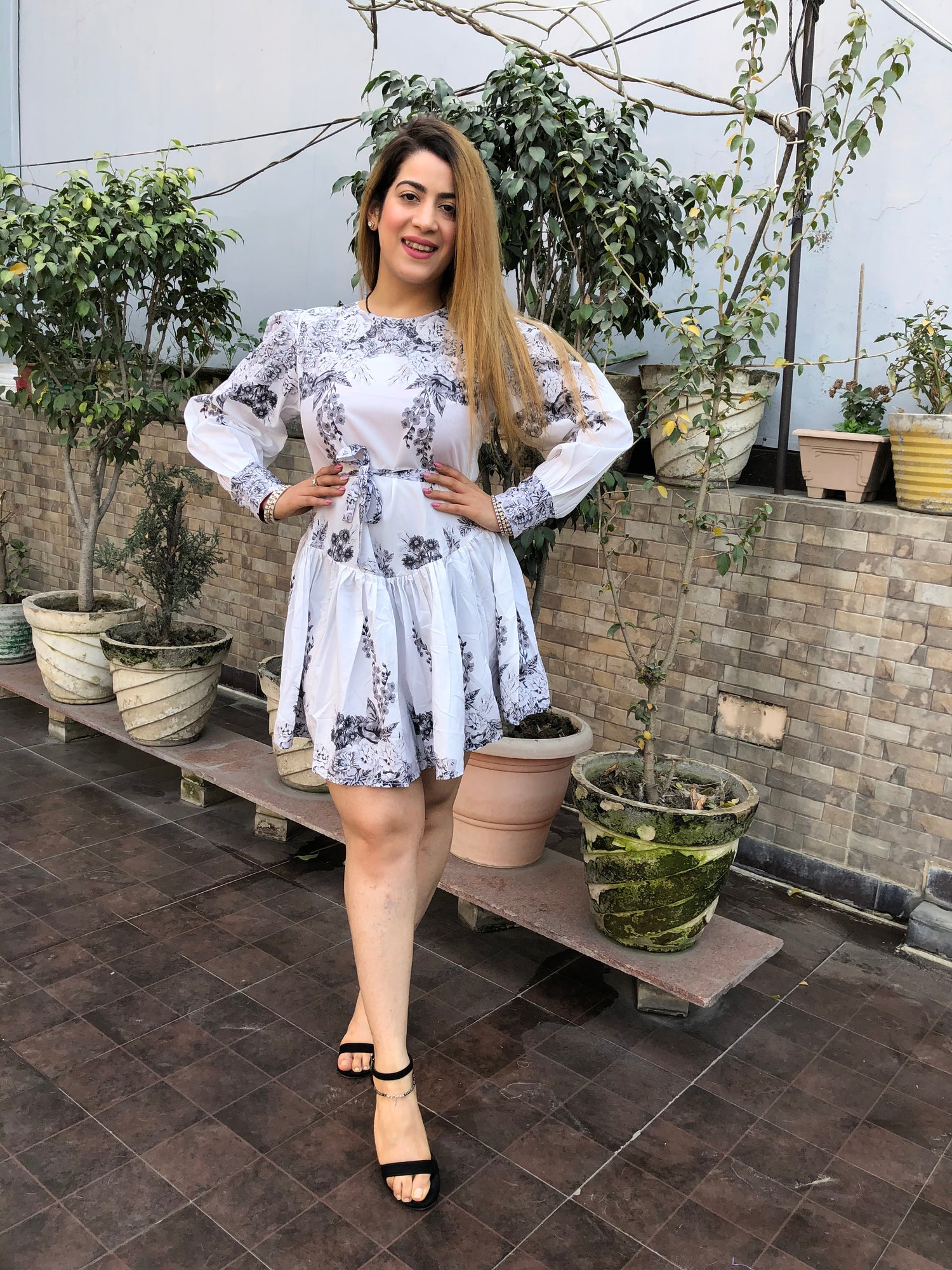 a woman wearing white floral skater dress