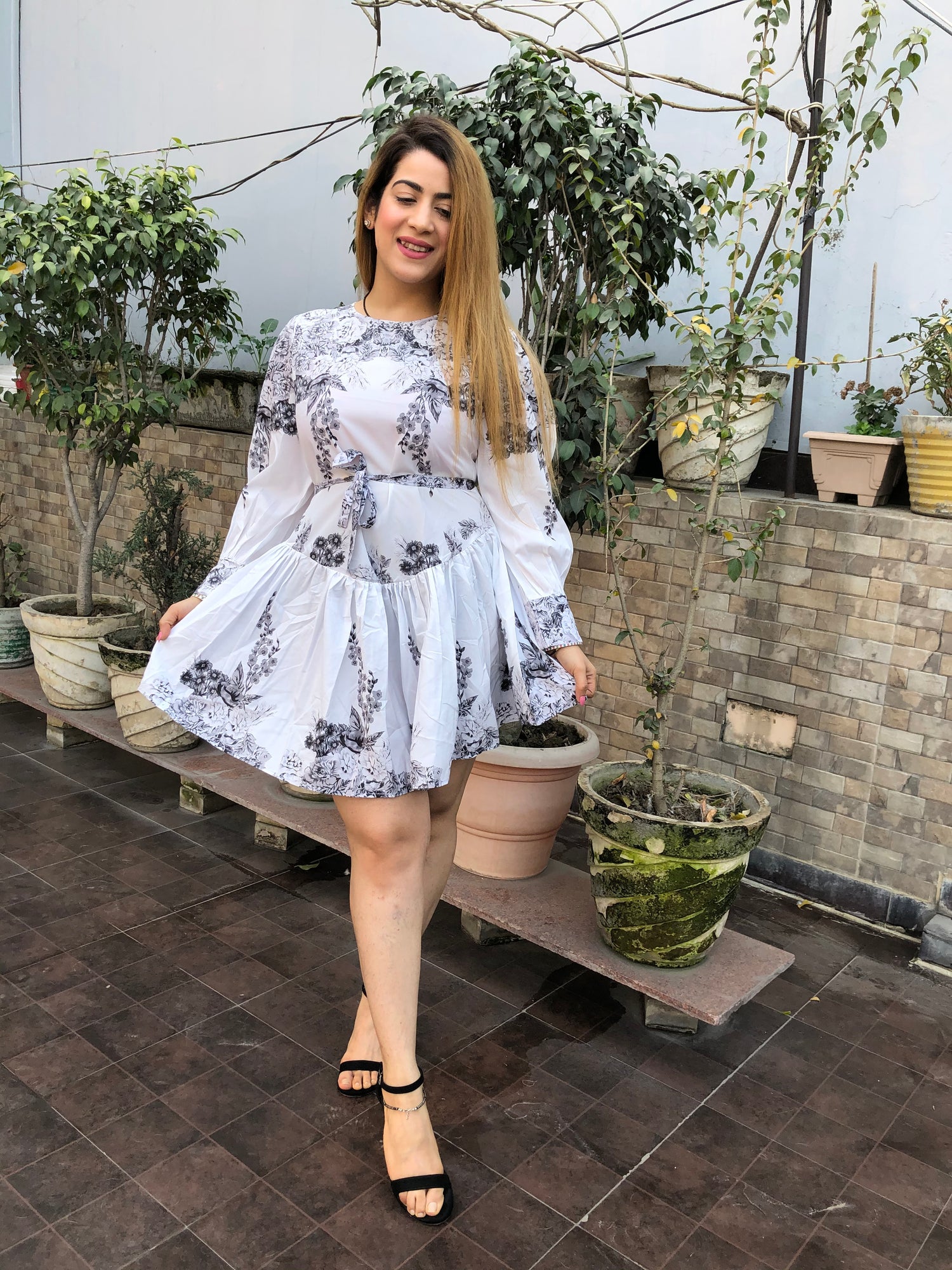 a woman wearing white floral skater dress