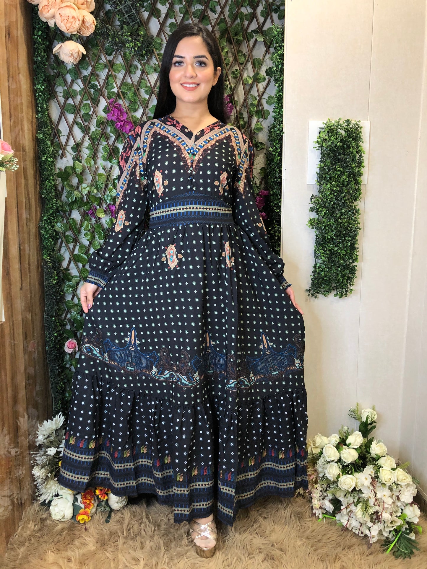 a woman wearing a black boho maxi dress