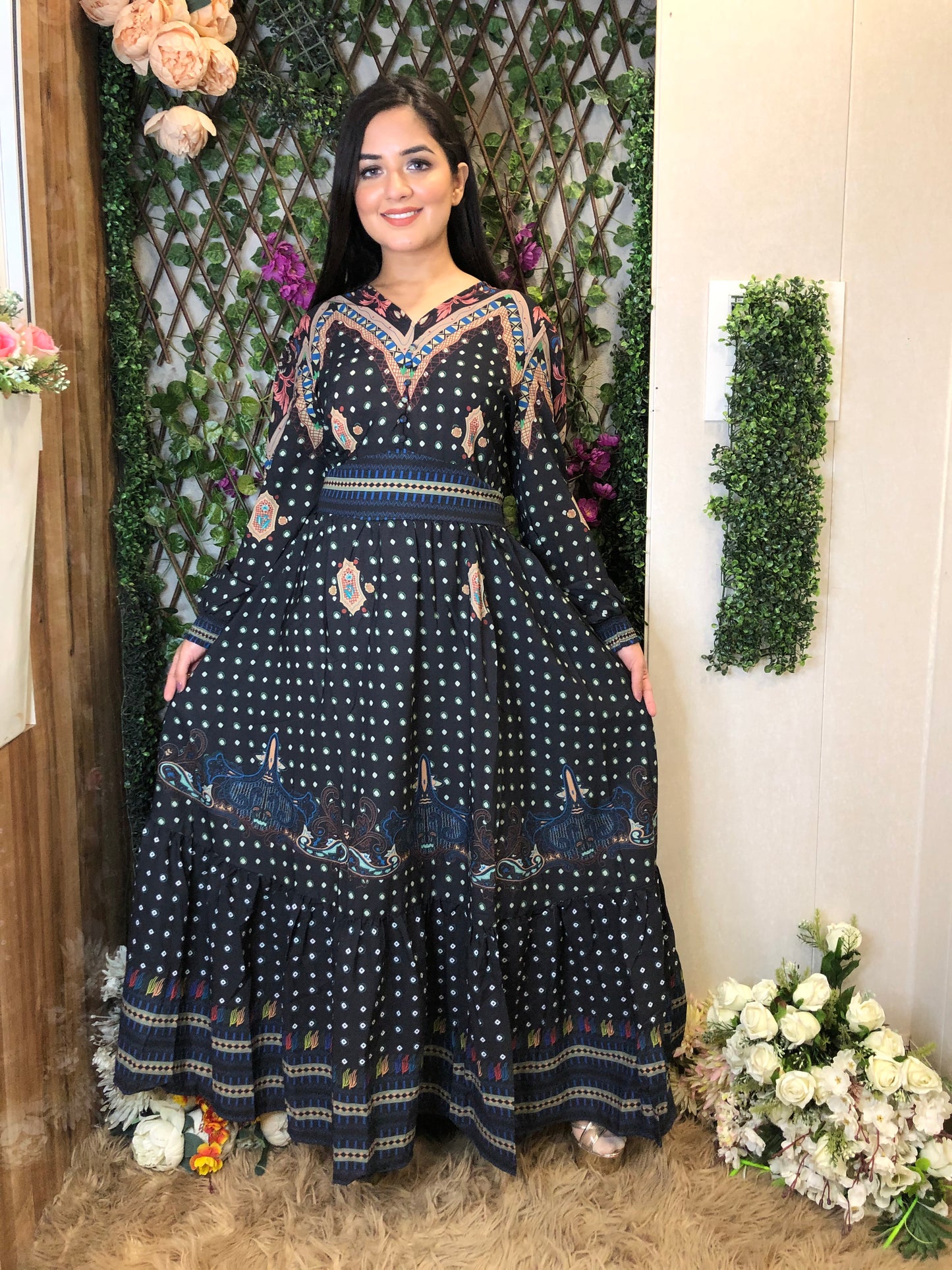 a woman wearing a black boho maxi dress