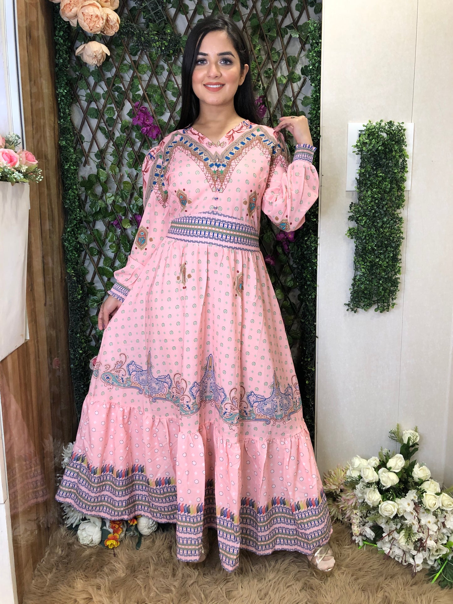 a woman wearing a pink boho maxi dress