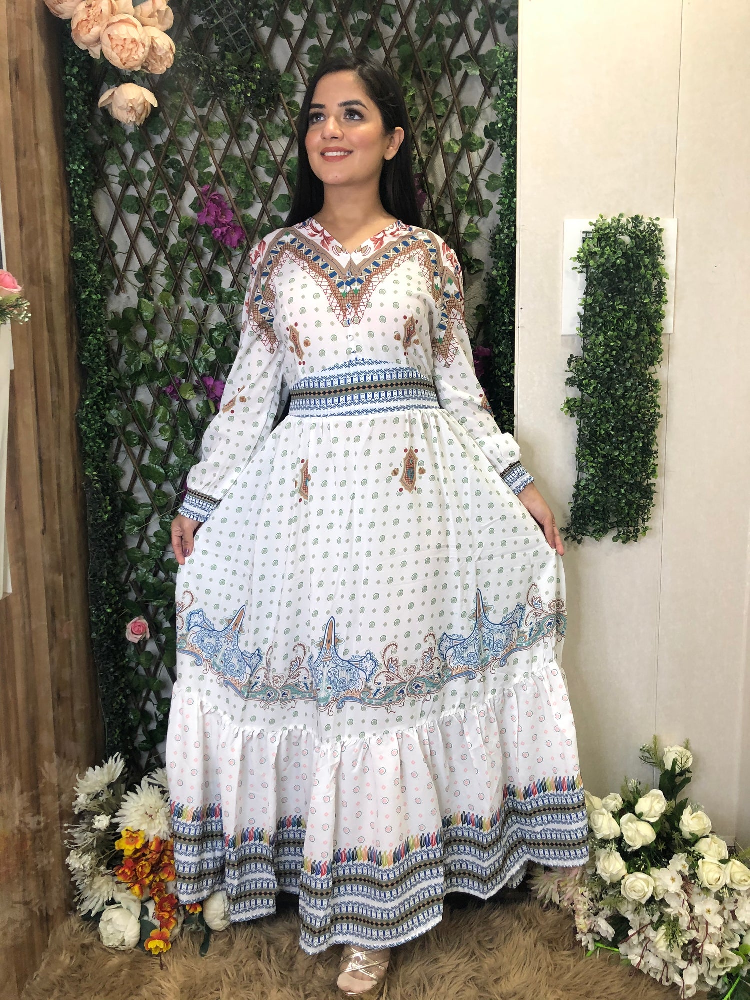 a woman wearing a white boho maxi dress