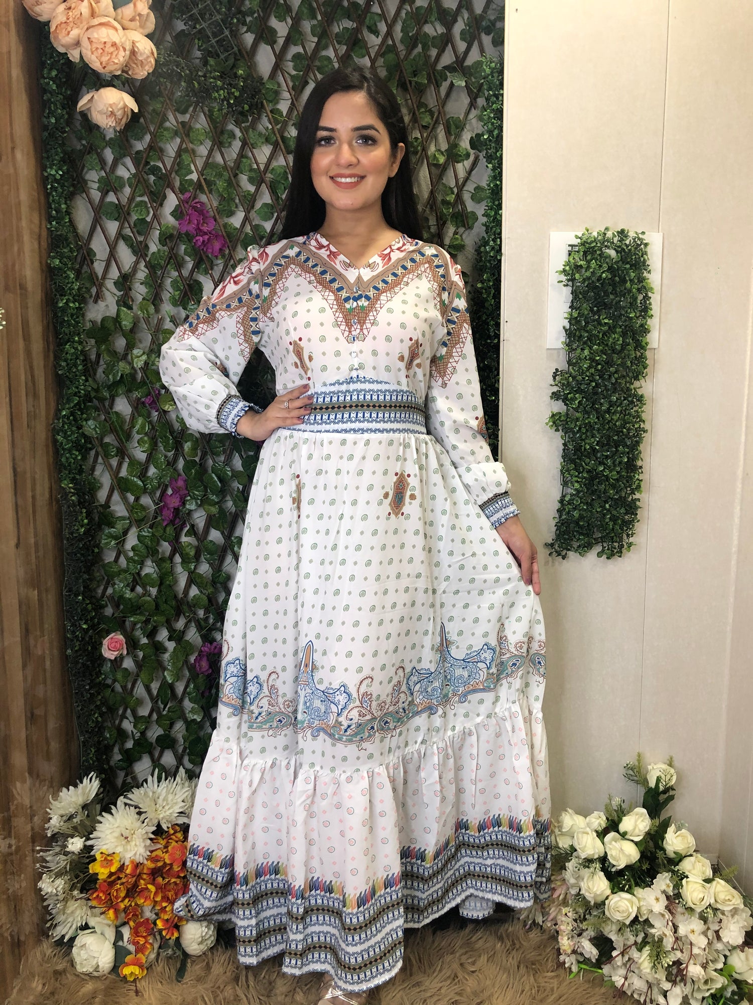 a woman wearing a white boho maxi dress