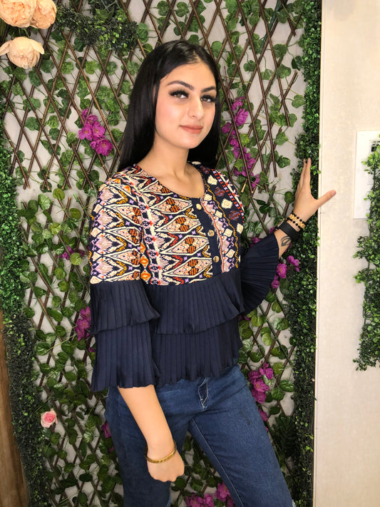 a woman wearing navy blue boho frill top